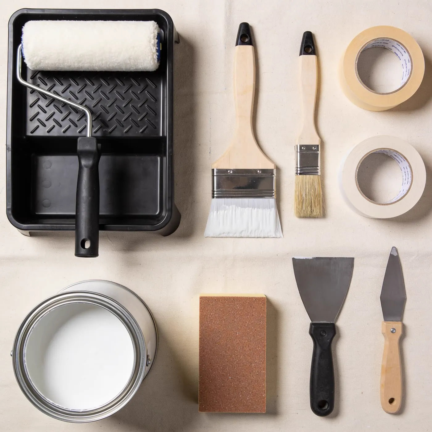 Professional painting tools laid out on a drop sheet